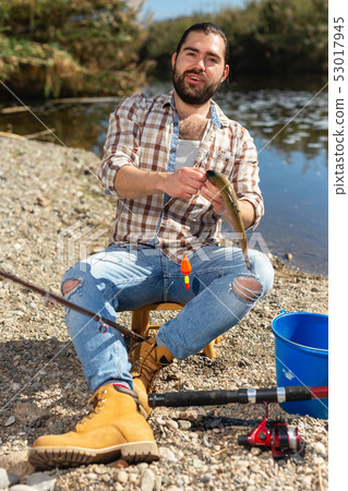 Lucky fisherman caught a trout fish Lucky fisherman caught a trout fish 53017945