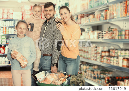 parents with girls with purchases during family shopping parents with girls with purchases during family shopping 53017949