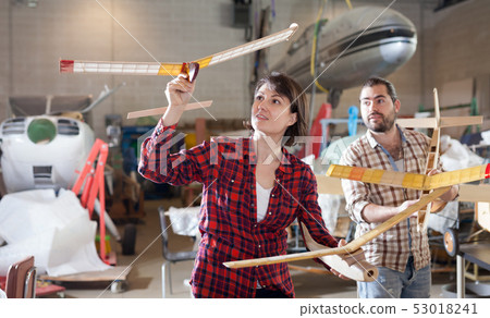 Couple having fun with plane models 53018241