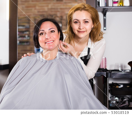 Adult woman likes very much her hairdress 53018519