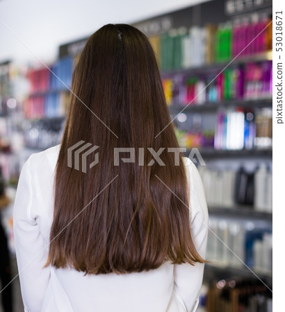 Portrait young female showing long hair, back view in studio Portrait young female showing long hair, back view in studio 53018671