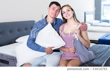 Portrait of attractive man and woman in mattress store Portrait of attractive man and woman in mattress store 53018783