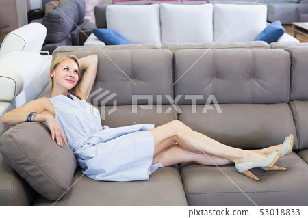 glad female is testing sofa in furniture store glad female is testing sofa in furniture store 53018833