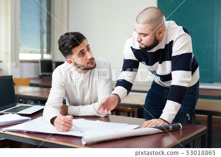 Students preparing for exams in classroom Students preparing for exams in classroom 53018865
