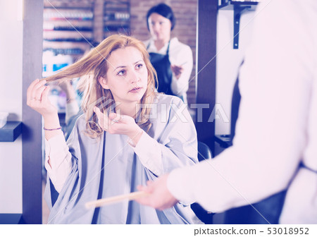 Young woman is not happy with her hair 53018952