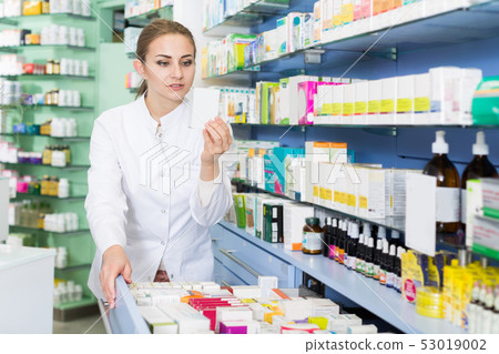 female chemist is searching medicine in drawers female chemist is searching medicine in drawers 53019002