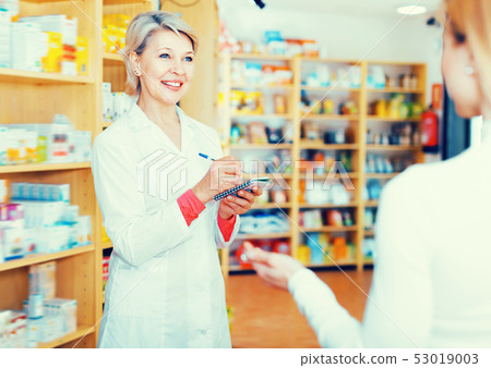 Happy woman recommending skin care products Happy woman recommending skin care products 53019003