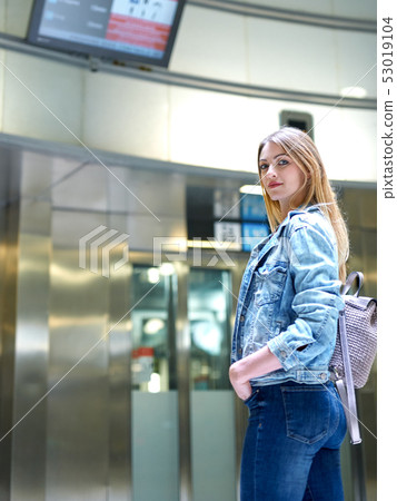 Girl with long hair looks train schedule in the subway Girl with long hair looks train schedule in the subway 53019104