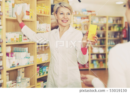 Seller helping customer to choose care products Seller helping customer to choose care products 53019130