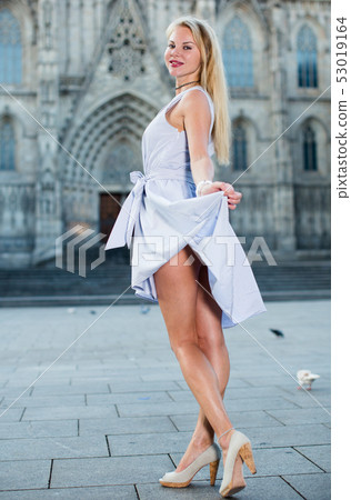 smiling woman holding dress in the hand smiling woman holding dress in the hand 53019164