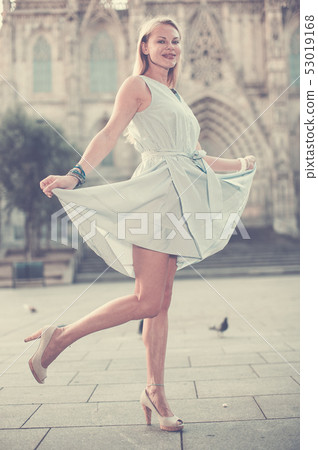 smiling woman holding dress in the hand smiling woman holding dress in the hand 53019168