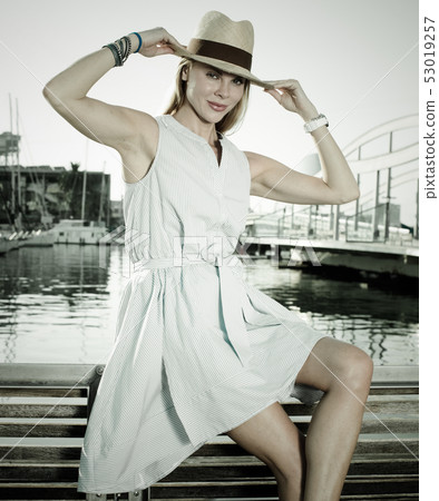 Portrait of smiling woman sitting in the hat 53019257