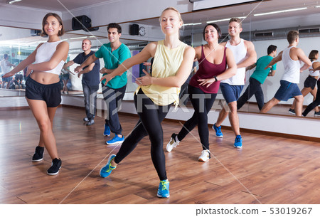 Men and ladies dancing zumba Men and ladies dancing zumba 53019267