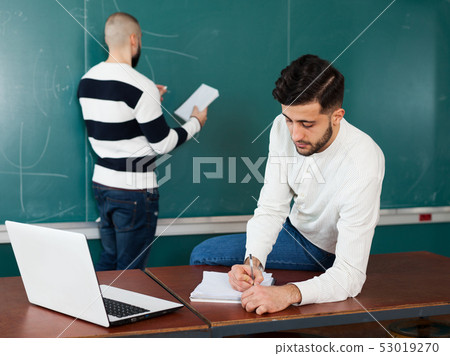 Two guys working on their student project Two guys working on their student project 53019270