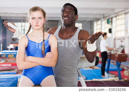 Coach soothing unhappy teenage girl Coach soothing unhappy teenage girl 53019286