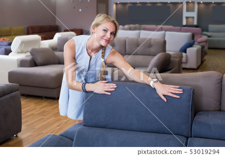 female buyer is happyning of choose new sofa 53019294