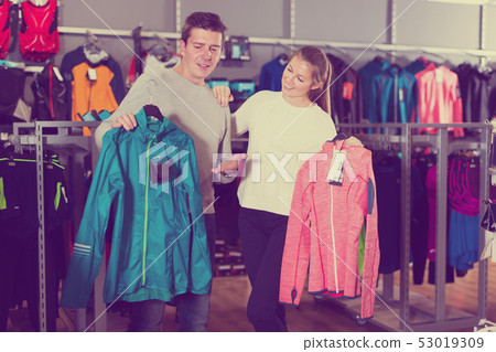 Couple choosing sports clothes 53019309