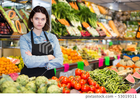 Female seller displaying assortment Female seller displaying assortment 53019311