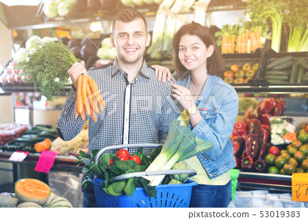 Couple choosing vegetables Couple choosing vegetables 53019383