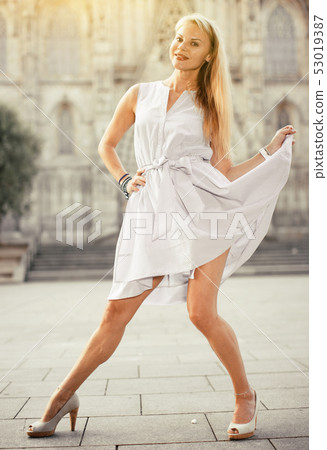 Glad female moving at the street in summer Glad female moving at the street in summer 53019387