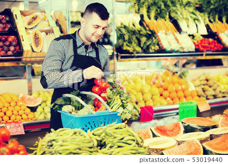Male seller helping to choose Male seller helping to choose 53019440