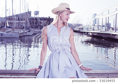 Portrait of smiling woman sitting in the hat Portrait of smiling woman sitting in the hat 53019455
