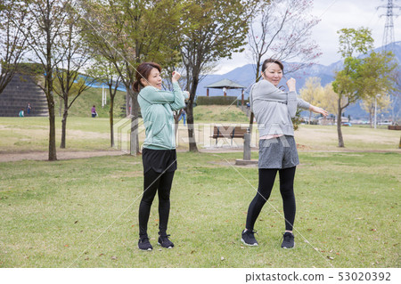 Woman doing radio exercises in the park 53020392