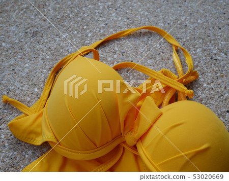 teen yellow bikini on pool and popular on beach. 53020669