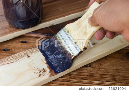 Paint brush with oil paint on wood Paint brush with oil paint on wood 53021004