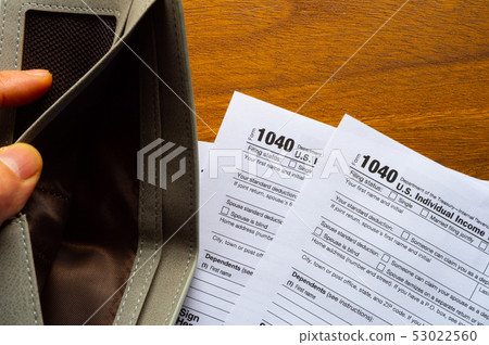 Tax day. The tax form 1040, and empty wallet  is 53022560