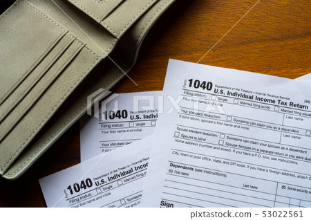 Tax day. The tax form 1040, and empty wallet  is 53022561