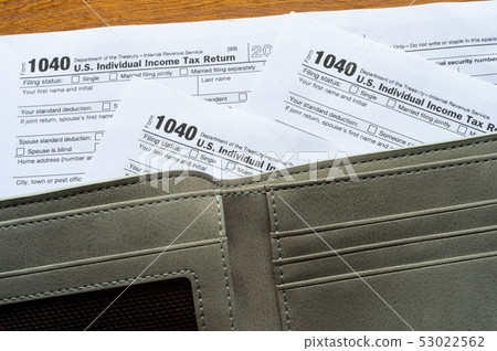 Tax day. The tax form 1040, and empty wallet  is 53022562