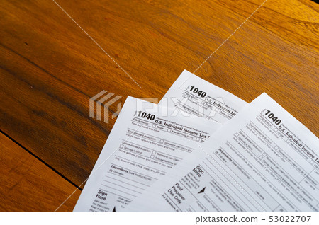 1040 Tax Return Form on the Dark Red Background 1040 Tax Return Form on the Dark Red Background 53022707