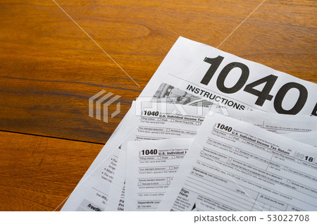1040 Tax Return Form on the Dark Red Background 1040 Tax Return Form on the Dark Red Background 53022708