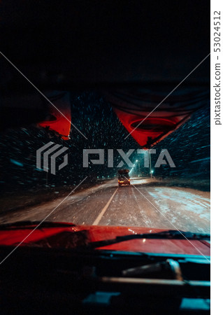 In car view of snowfall storm on the countryside road 53024512