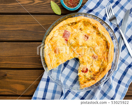 Rustic large tart with cloth on a wooden table, view from above, close-up 53025922