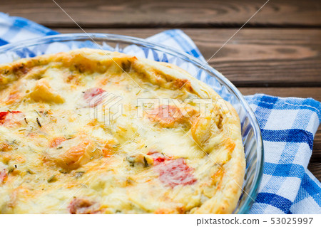Rustic large tart with cloth on a wooden table, view from above, close-up 53025997
