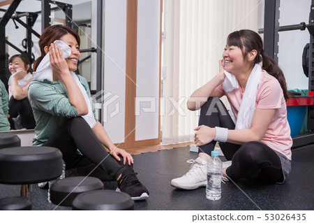 Woman taking a break at the gym Woman taking a break at the gym 53026435