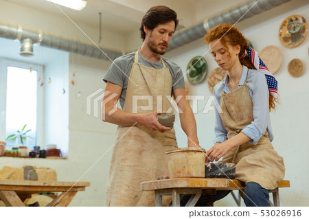 Concentrated professional couple working in equipped studio 53026916