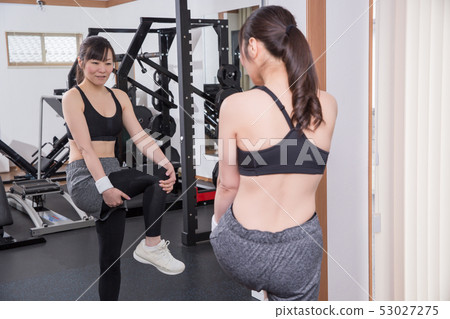 Woman doing leg stretching in the gym 53027275