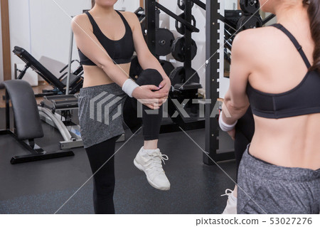 Woman doing leg stretching in the gym 53027276