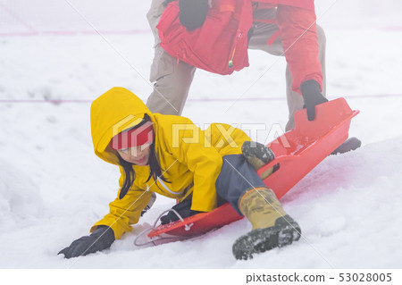 Father is helping her daughter to ride the snow Father is helping her daughter to ride the snow 53028005