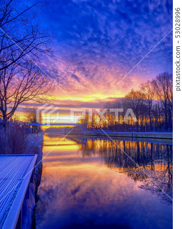 Dramatic and colorful sunrise over a beautiful river landscape 53028996