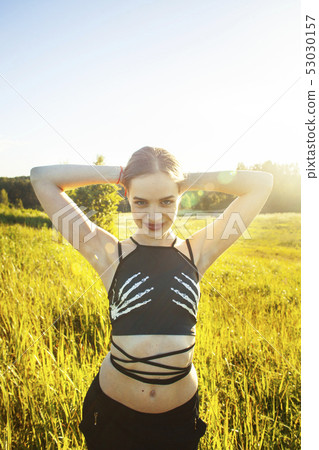young pretty girl posing cheerful in green grass outside, enjoing nature, lifestyle people concept 53030157