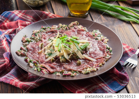 Beef carpaccio with arugula and parmesan Beef carpaccio with arugula and parmesan 53036513