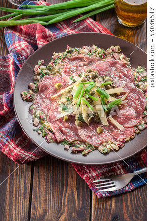 Beef carpaccio with arugula and parmesan Beef carpaccio with arugula and parmesan 53036517