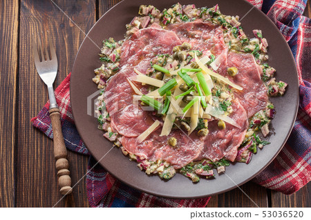 Beef carpaccio with arugula and parmesan Beef carpaccio with arugula and parmesan 53036520