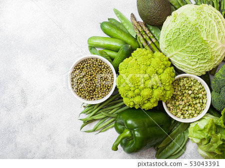 Assorted green toned raw organic vegetables on 53043391