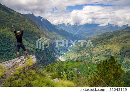 Man standing on hill top in Himalayas Man standing on hill top in Himalayas 53045119