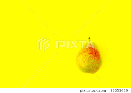 Appetizing ripe pear with red side on a yellow background. Appetizing ripe pear with red side on a yellow background. 53055629